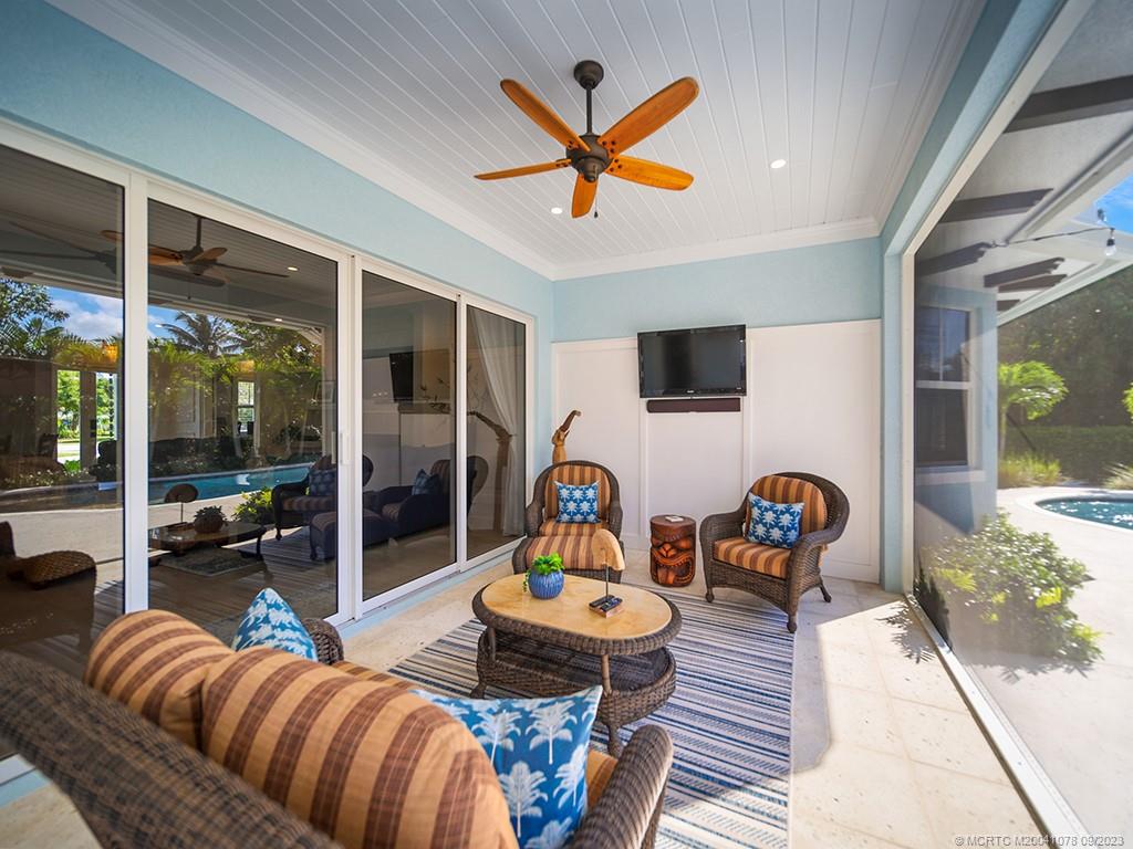5714 Southeast Horseshoe Point Road Stuart, FL 34997 - Photo 54 of 83 a living room with furniture and a large window