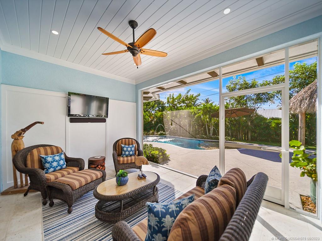 5714 Southeast Horseshoe Point Road Stuart, FL 34997 - Photo 55 of 83 a living room with furniture and a large window