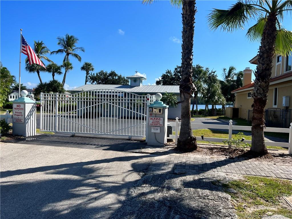 5714 Southeast Horseshoe Point Road Stuart, FL 34997 - Photo 73 of 83 a view of a street with a bench and flower plants