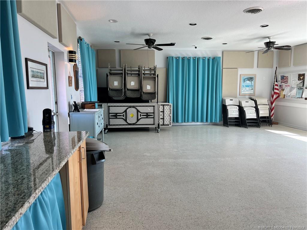 5714 Southeast Horseshoe Point Road Stuart, FL 34997 - Photo 78 of 83 a living room with furniture and a flat screen tv