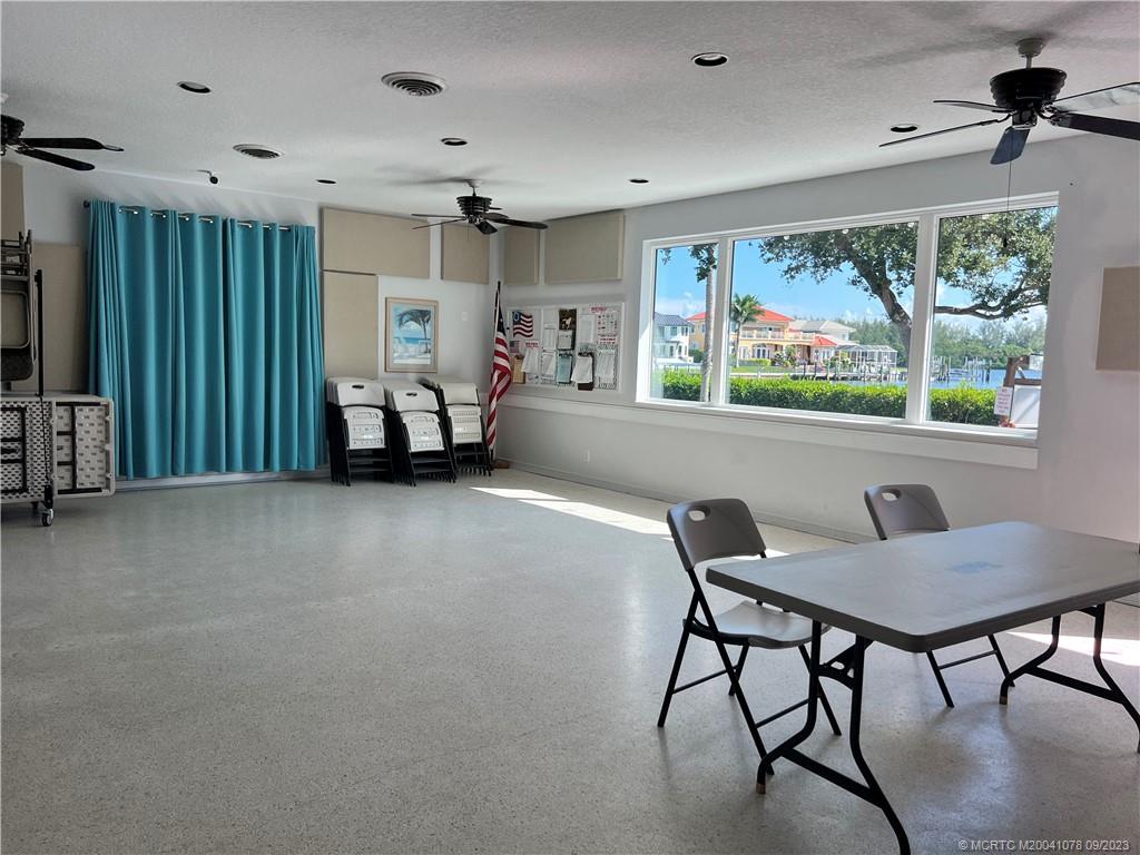 5714 Southeast Horseshoe Point Road Stuart, FL 34997 - Photo 79 of 83 a living room with furniture and a large window