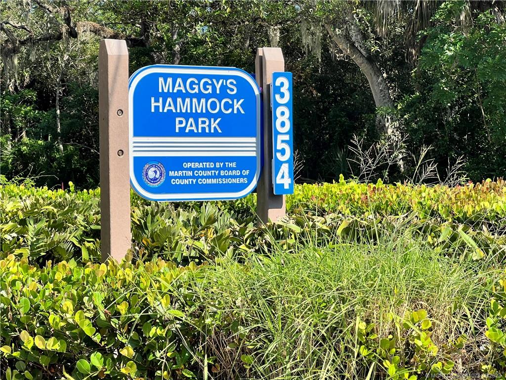 5714 Southeast Horseshoe Point Road Stuart, FL 34997 - Photo 81 of 83 a sign that is sitting in front of flowers