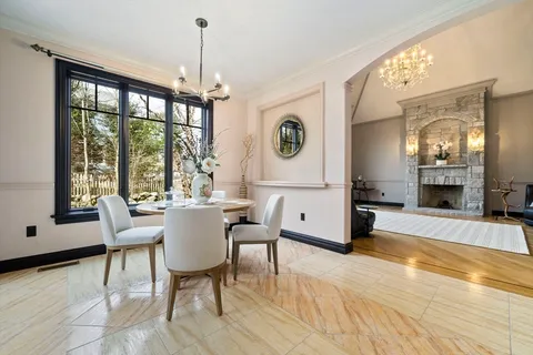 a view of an empty room with furniture a fireplace and windows