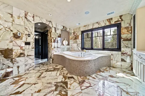 a bedroom with a bed and a view of bathroom