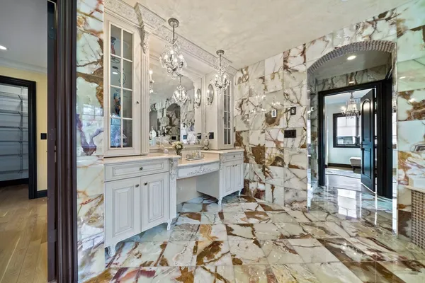 a bathroom with double vanity sink a mirror and a shower