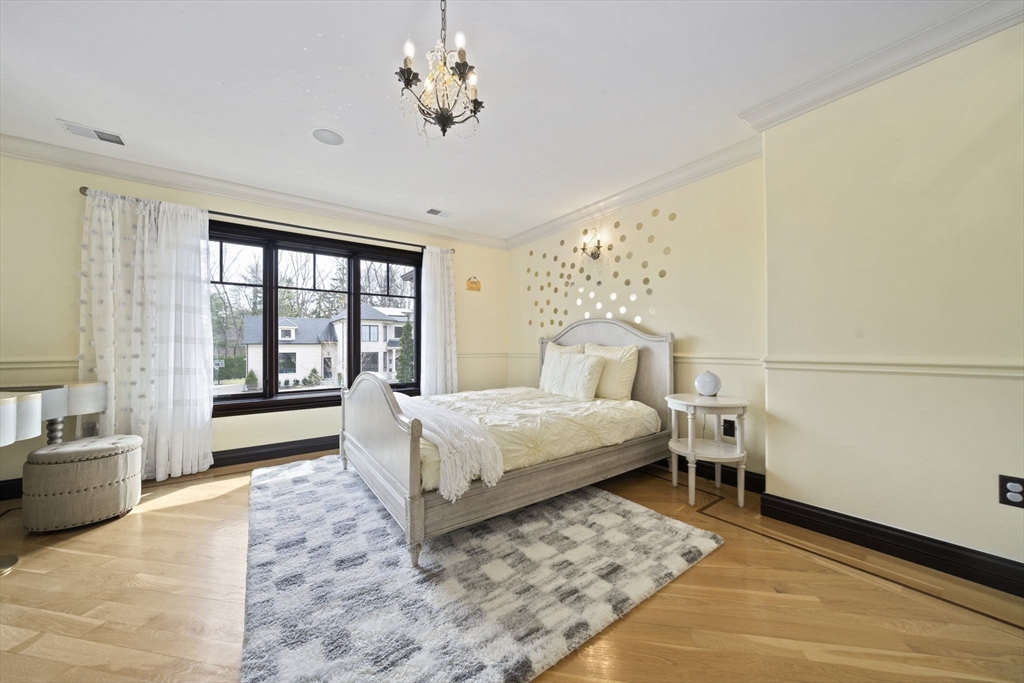 20 Boulder Road Newton, MA 02459 - Photo 23 of 42 a bedroom with a large bed and a chandelier