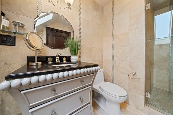 a bathroom with a toilet a sink and a mirror