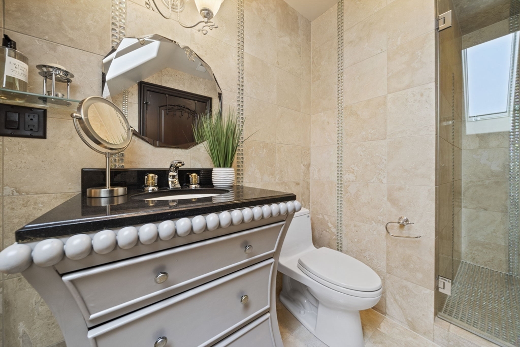 20 Boulder Road Newton, MA 02459 - Photo 28 of 42 a bathroom with a toilet a sink and a mirror