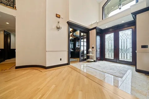 a view of a dining room with furniture a chandelier and wooden floor