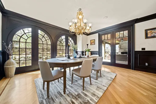 a view of a dining room with furniture a chandelier and wooden floor