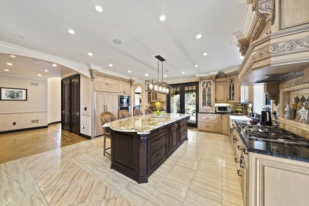 20 Boulder Road Newton, MA 02459 - Photo 9 of 42 a large kitchen with stainless steel appliances kitchen island granite countertop a large counter top and stove