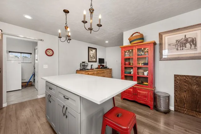 a view of a room with furniture and wooden floor