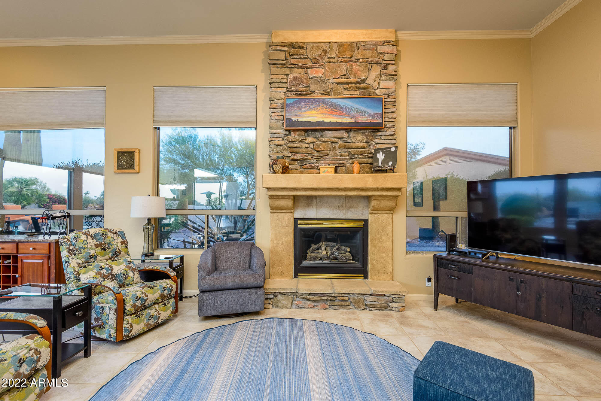 7754 East La Junta Road Scottsdale, AZ 85255 - Photo 26 of 72 a living room with furniture a flat screen tv and a fireplace