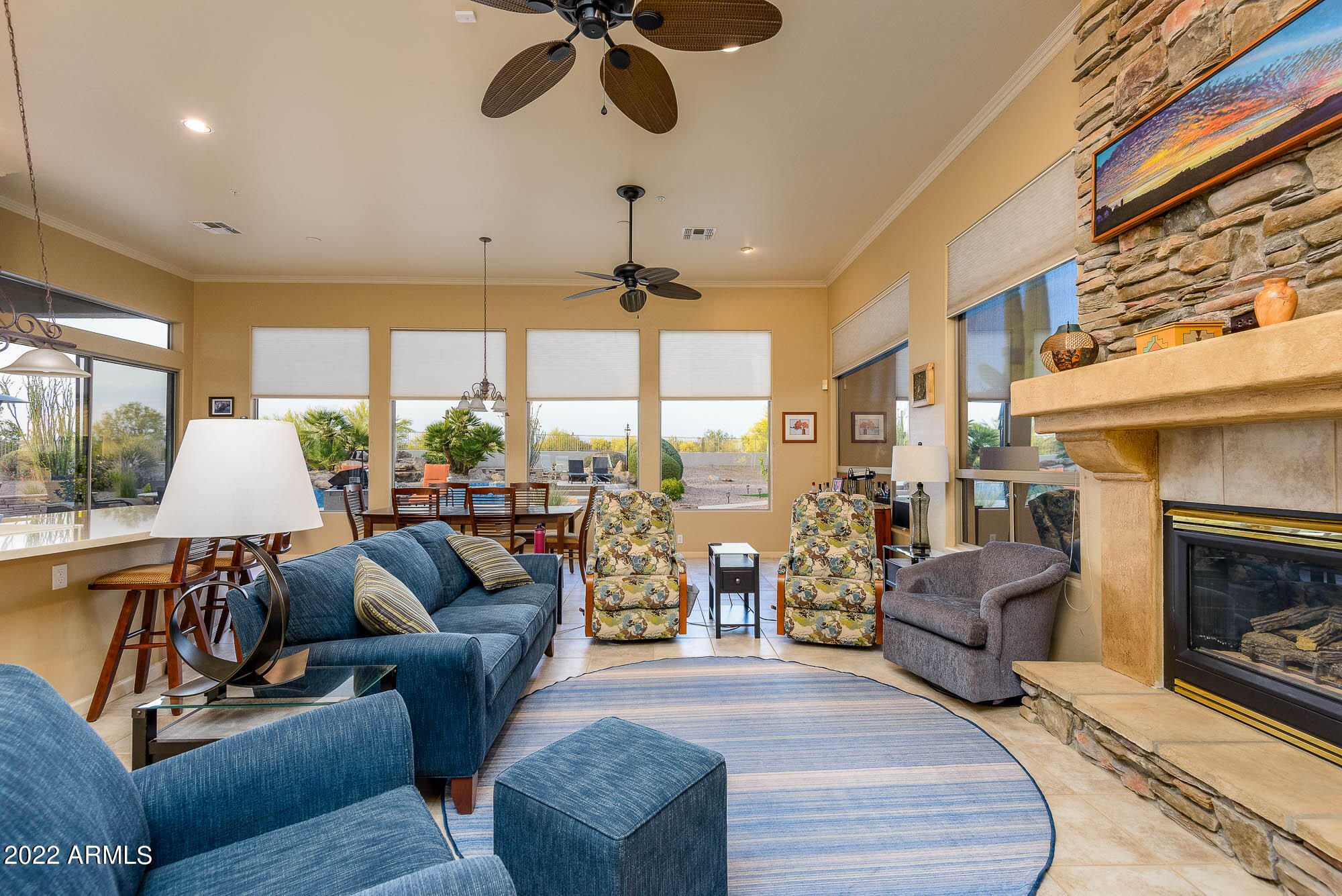 7754 East La Junta Road Scottsdale, AZ 85255 - Photo 27 of 72 a living room with furniture a fireplace and a chandelier