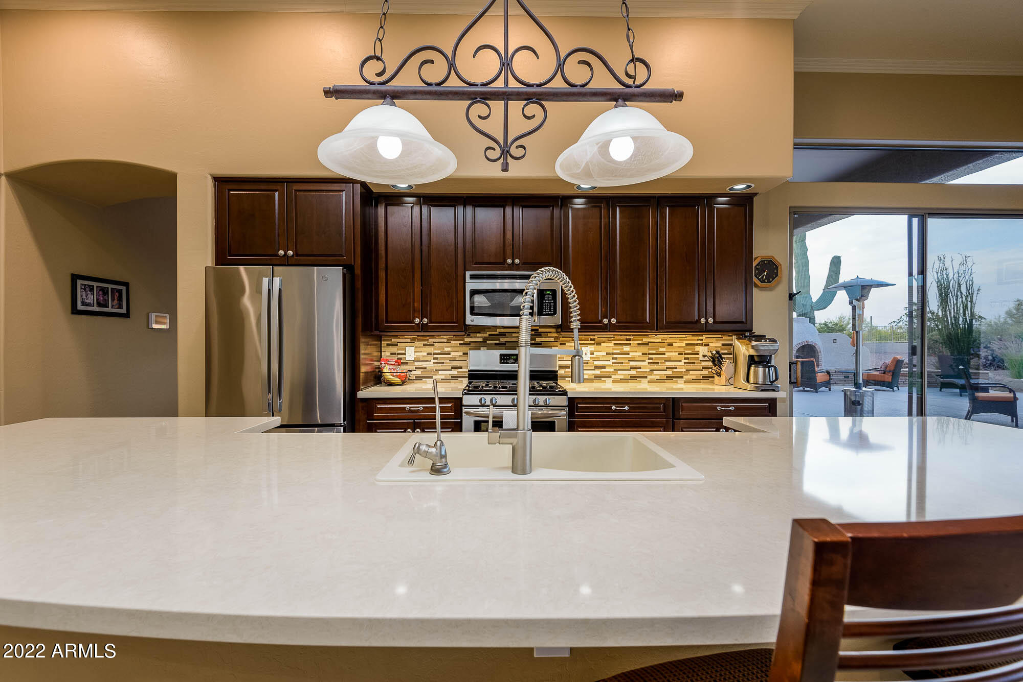 7754 East La Junta Road Scottsdale, AZ 85255 - Photo 31 of 72 a kitchen with stainless steel appliances wooden cabinets a stove top oven a sink and dishwasher