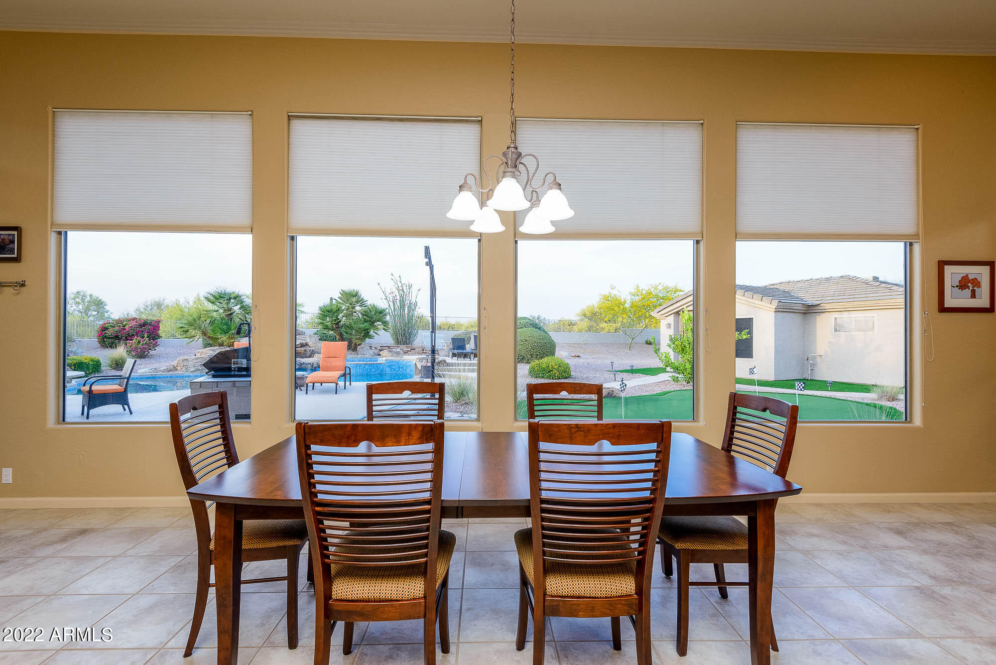 7754 East La Junta Road Scottsdale, AZ 85255 - Photo 34 of 72 a view of a dining room with furniture a chandelier and wooden floor