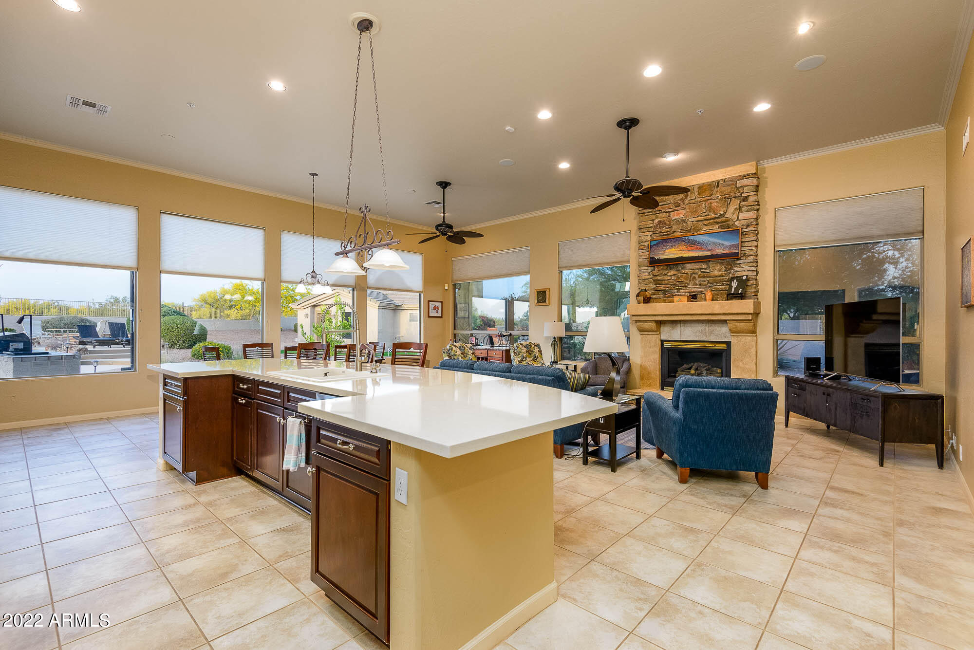 7754 East La Junta Road Scottsdale, AZ 85255 - Photo 35 of 72 a large kitchen with a large counter top a stove a sink a dining table and chairs