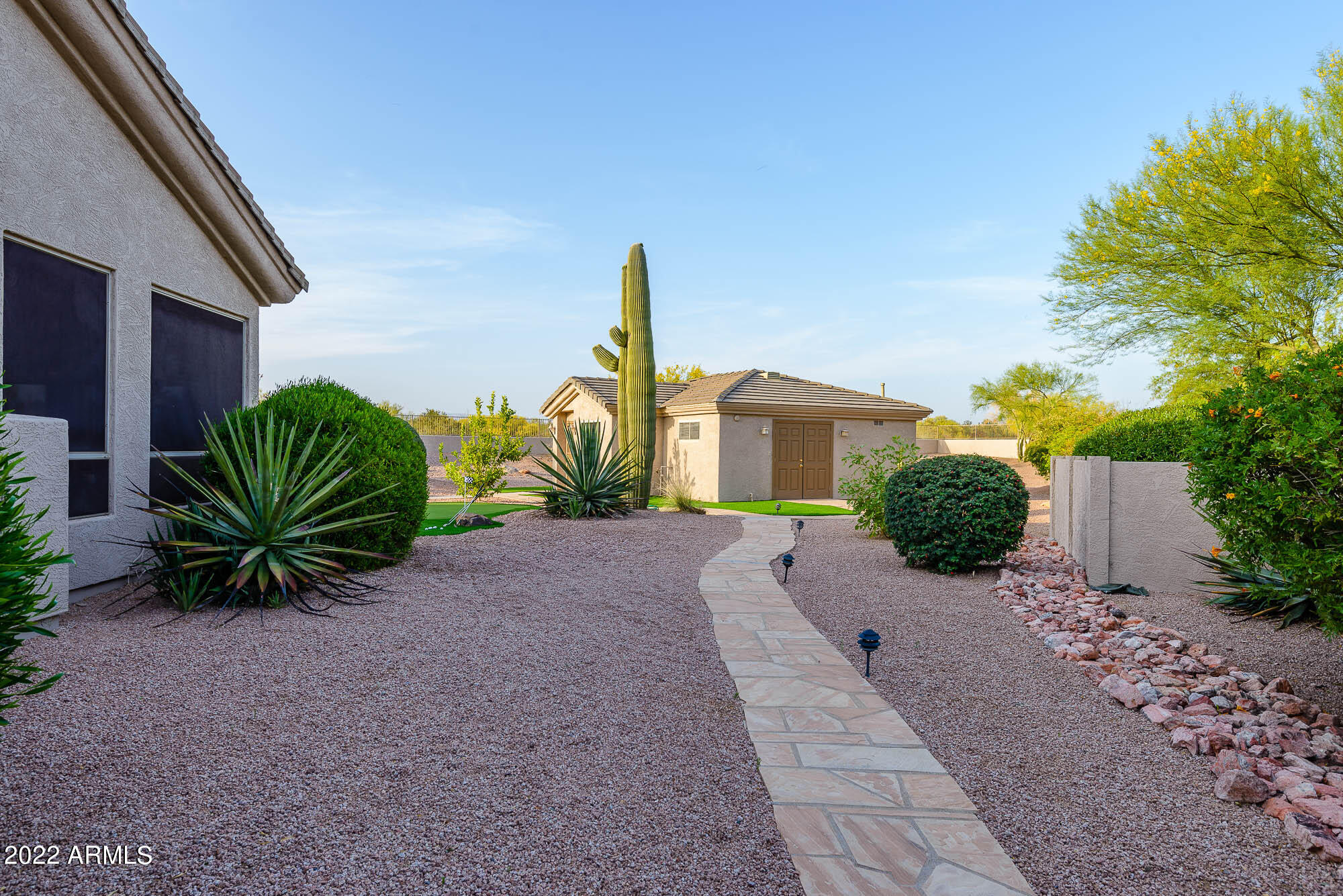 7754 East La Junta Road Scottsdale, AZ 85255 - Photo 36 of 72 a front view of a house with a yard and a garage