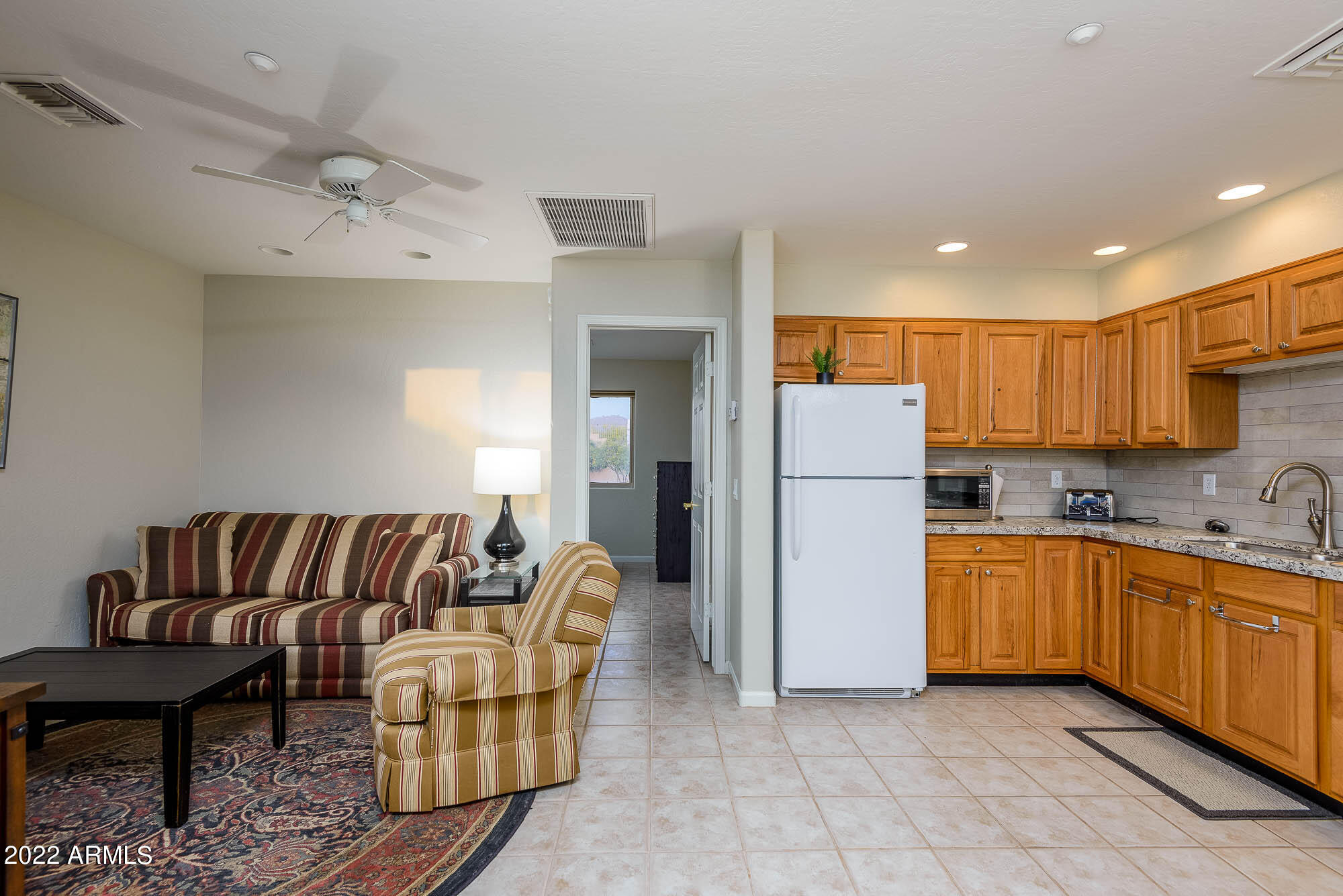 7754 East La Junta Road Scottsdale, AZ 85255 - Photo 39 of 72 a kitchen with stainless steel appliances granite countertop a refrigerator and a sink