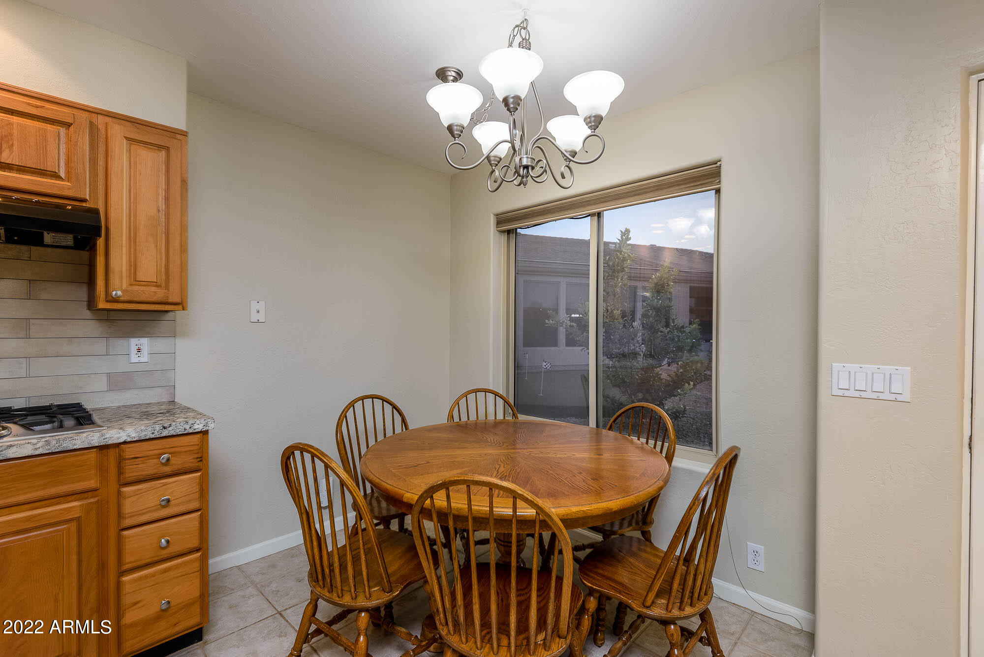 7754 East La Junta Road Scottsdale, AZ 85255 - Photo 41 of 72 a view of a dining room with furniture and chandelier