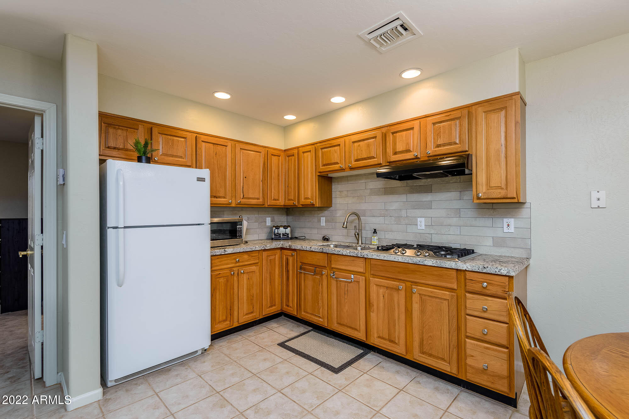 7754 East La Junta Road Scottsdale, AZ 85255 - Photo 42 of 72 a kitchen with granite countertop stainless steel appliances a refrigerator a stove top oven and sink