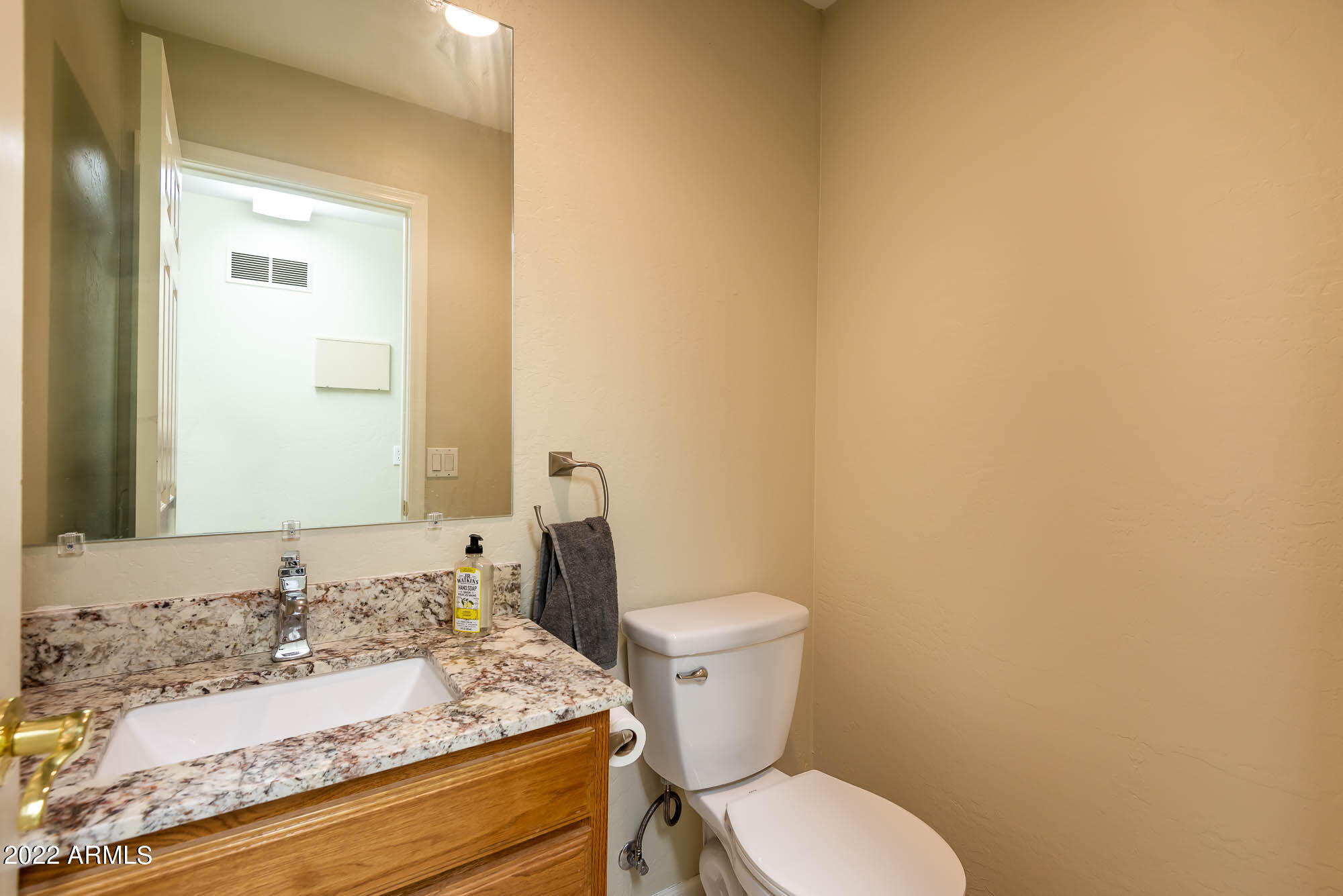 7754 East La Junta Road Scottsdale, AZ 85255 - Photo 50 of 72 a bathroom with a granite countertop toilet and a sink