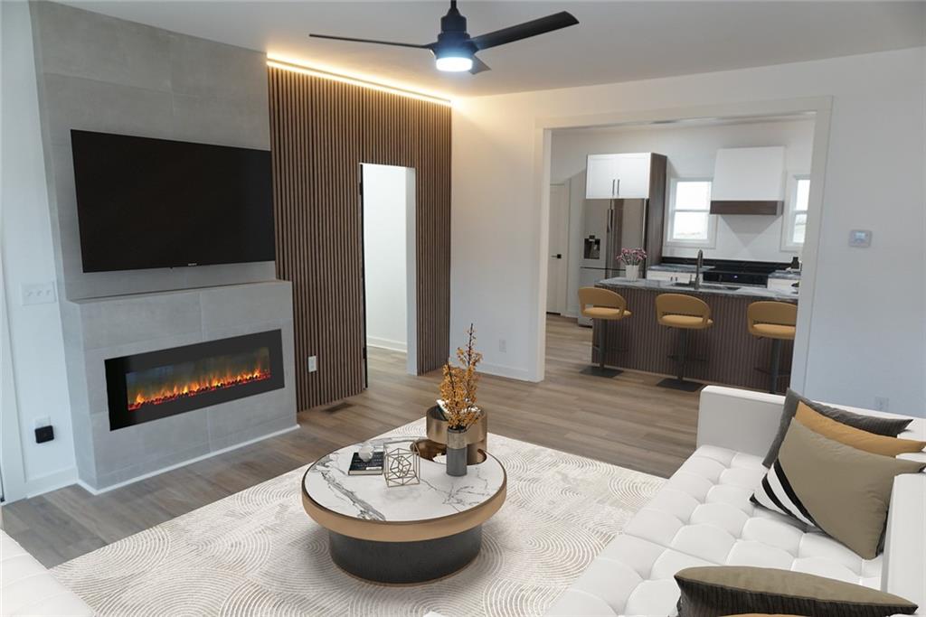 a living room with furniture a fireplace and a flat screen tv