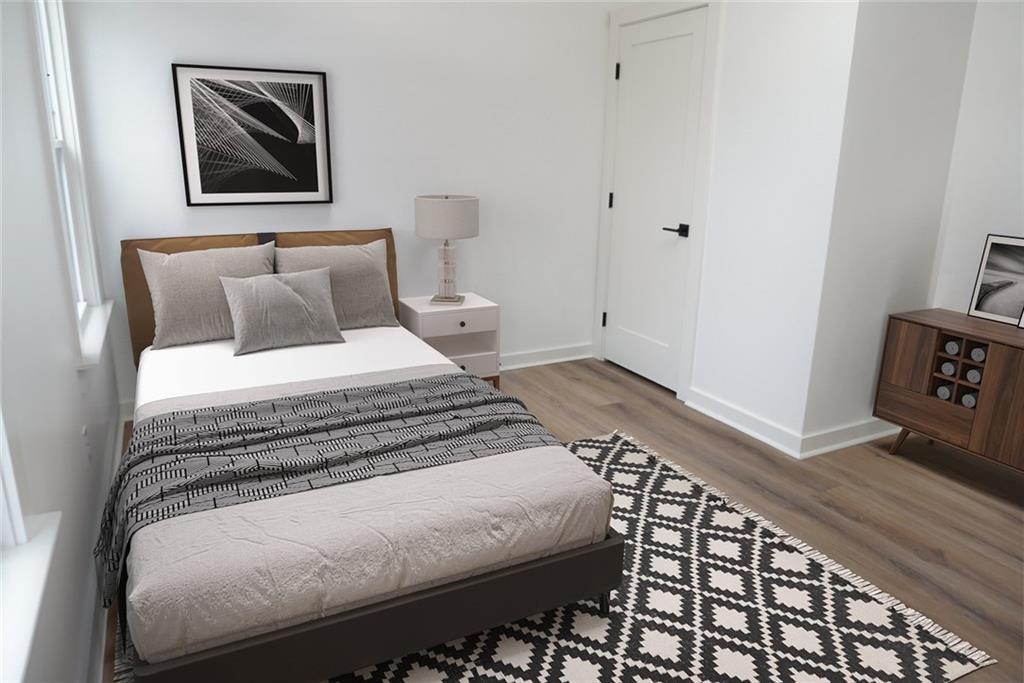 708 Rochelle Drive Southwest Atlanta, GA 30310 - Photo 13 of 24 a bedroom with bed and wooden floor