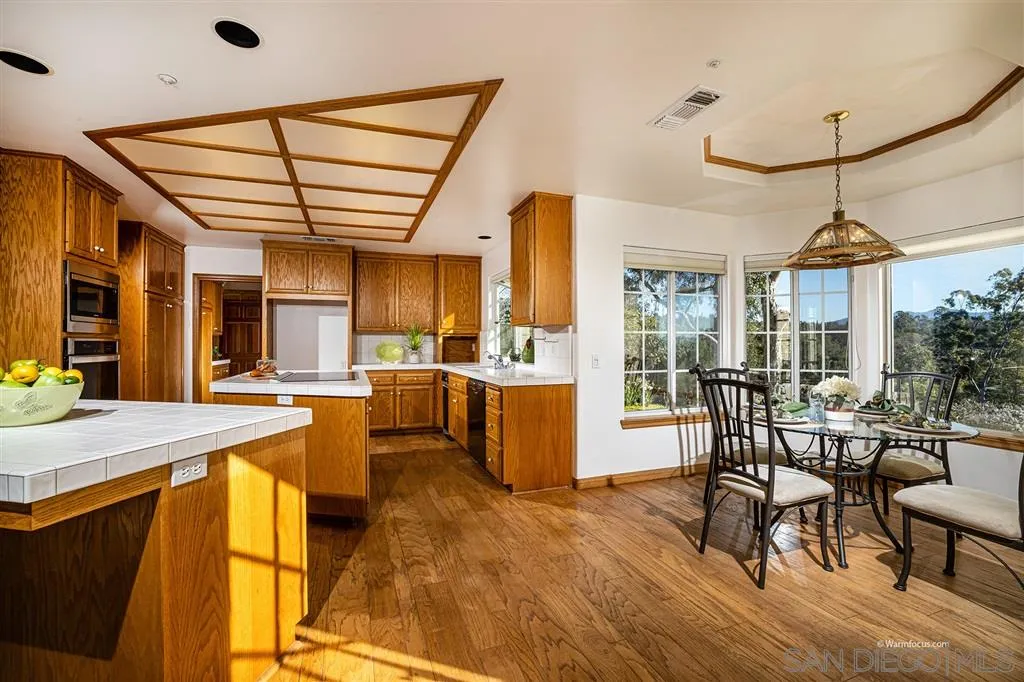 1237 Live Oak Park Road South Fallbrook, CA 92028 - Photo 8 of 25 a view of a dining room with furniture window and wooden floor