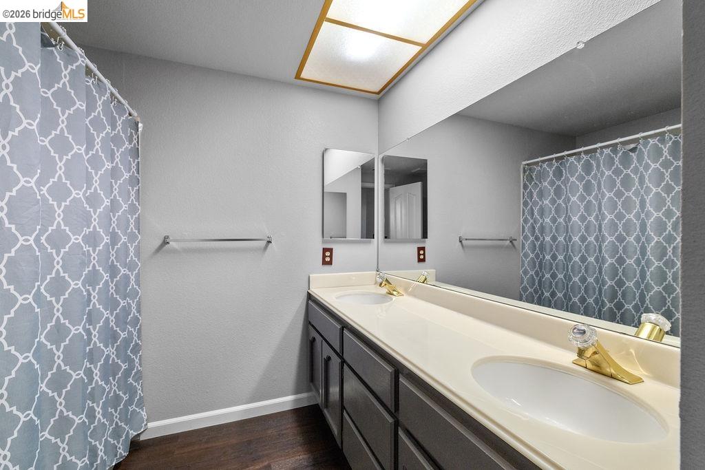 724 Winterside Circle San Ramon, CA 94583 - Photo 29 of 43 Bathroom featuring a double vanity with gray cabinetry, white countertops, and dual undermount sinks