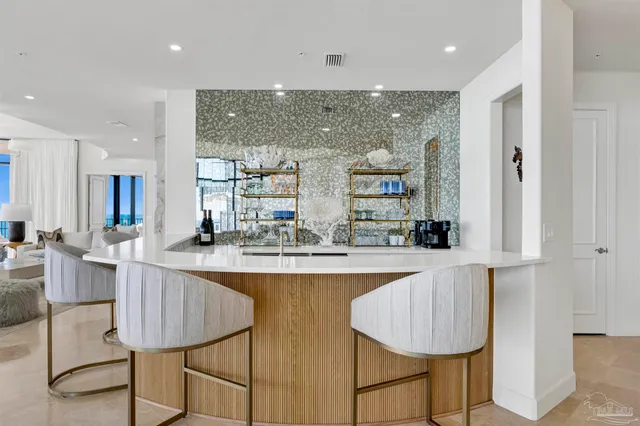 a kitchen with kitchen island a appliances dining table and chairs