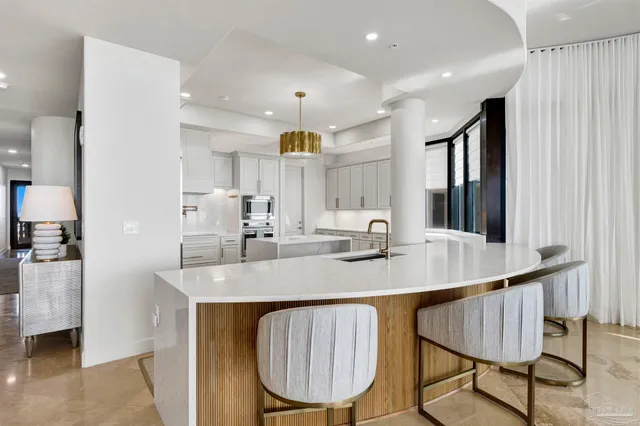 a kitchen with stainless steel appliances a refrigerator sink and cabinets