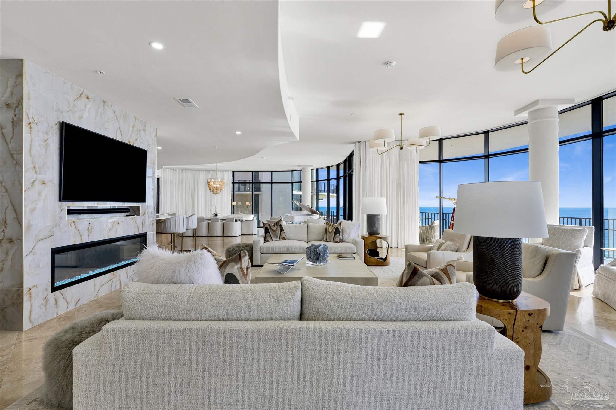 16551 Perdido Key Drive, Unit PH701 Perdido Key, FL 32507 - Photo 28 of 62 a living room with fireplace furniture and a flat screen tv