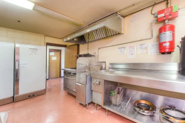 a kitchen with a stove and cabinets