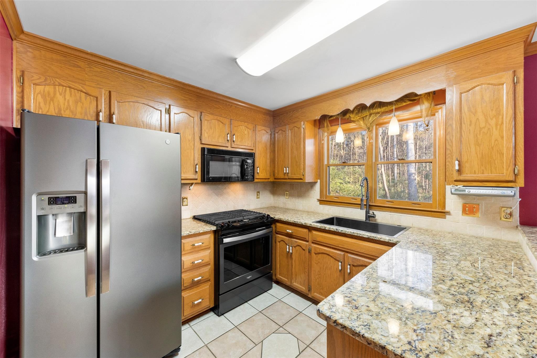 3026 Forbes Road Gastonia, NC 28056 - Photo 13 of 42 a kitchen with stainless steel appliances granite countertop a refrigerator a sink and a stove
