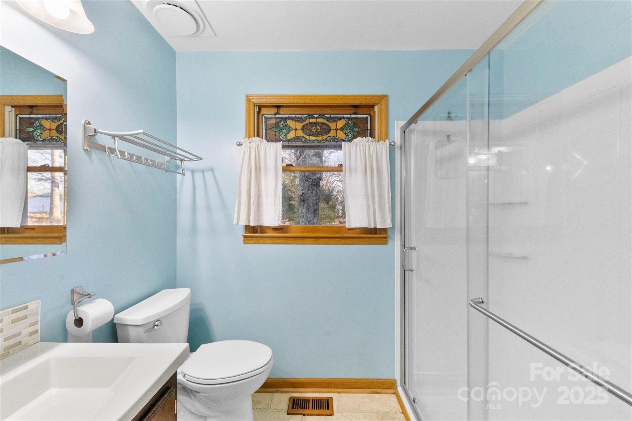 3026 Forbes Road Gastonia, NC 28056 - Photo 26 of 42 a bathroom with a toilet a sink and a shower