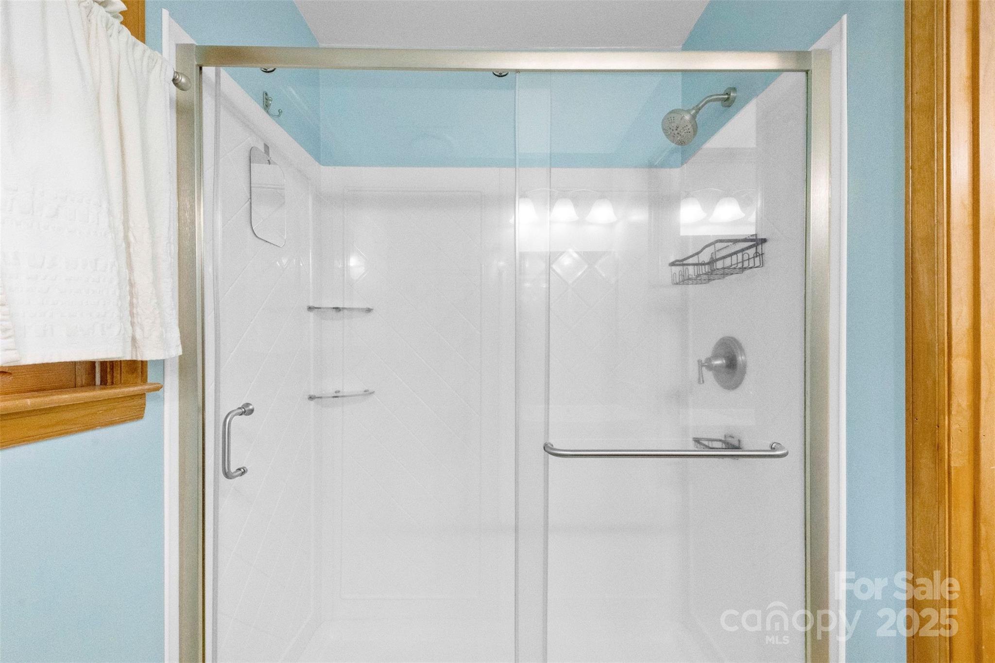 3026 Forbes Road Gastonia, NC 28056 - Photo 27 of 42 a bathroom with a glass shower door