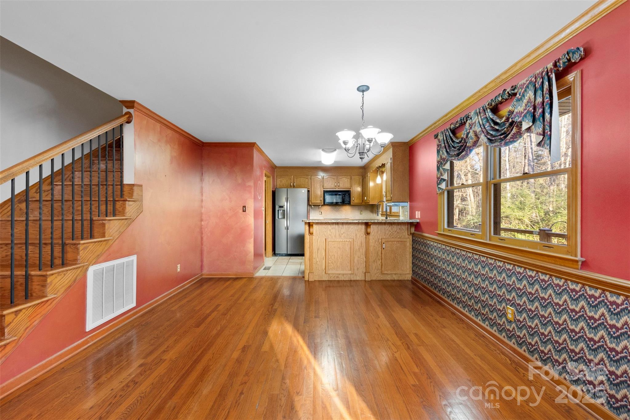 3026 Forbes Road Gastonia, NC 28056 - Photo 9 of 42 a large kitchen with cabinets wooden floor and stainless steel appliances