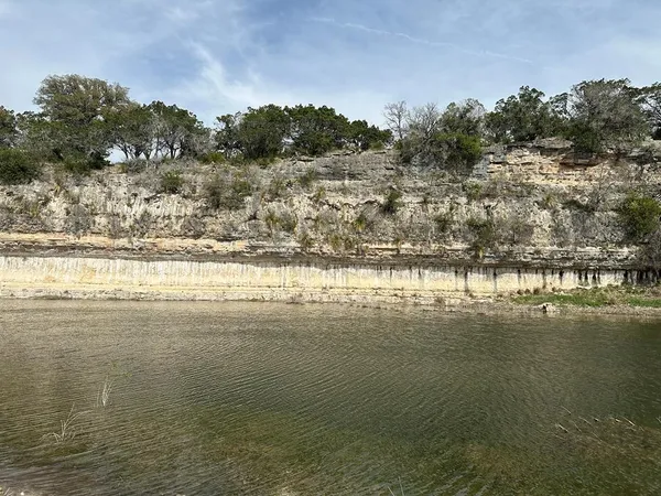 a view of a lake with houses in the background