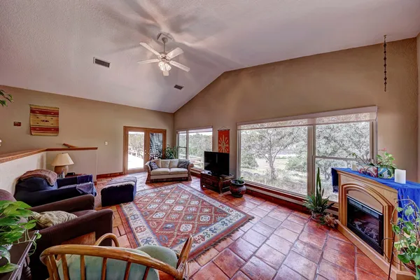 a living room with furniture a large window and a flat screen tv