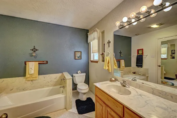 a bedroom with furniture and a large window