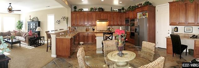 2630 Friesian Court Reno, NV 89521 - Photo 6 of 9 a view of a dining room with furniture a kitchen and chandelier