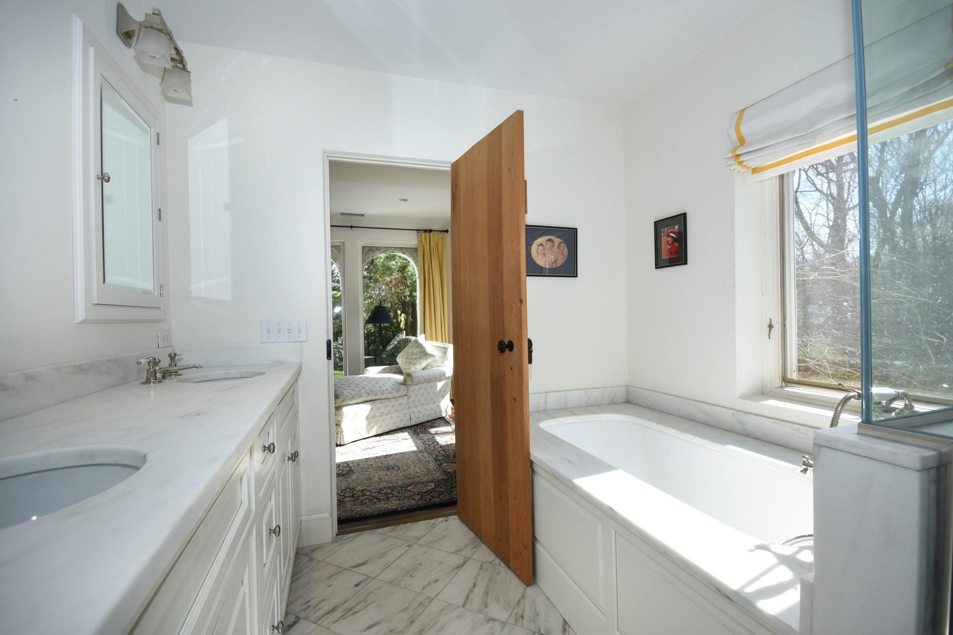 446 Hollow Tree Ridge Road, Unit 4 Darien, CT 06820 - Photo 32 of 37 a bathroom with a granite countertop sink mirror bathtub and toilet