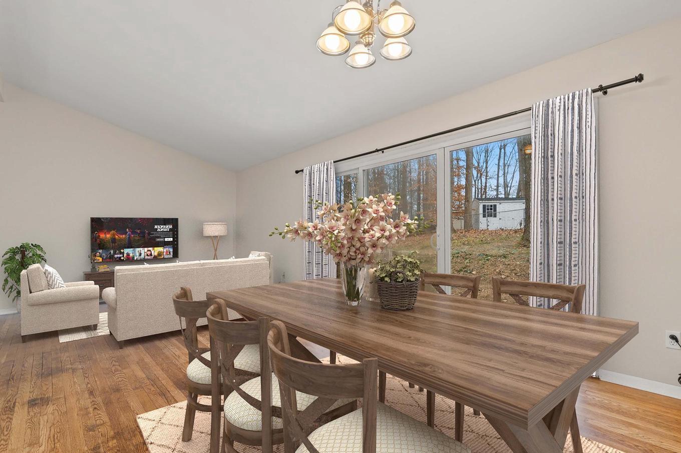 6505 Farley Street Springfield, VA 22152 - Photo 6 of 30 a dining room with furniture a chandelier and wooden floor