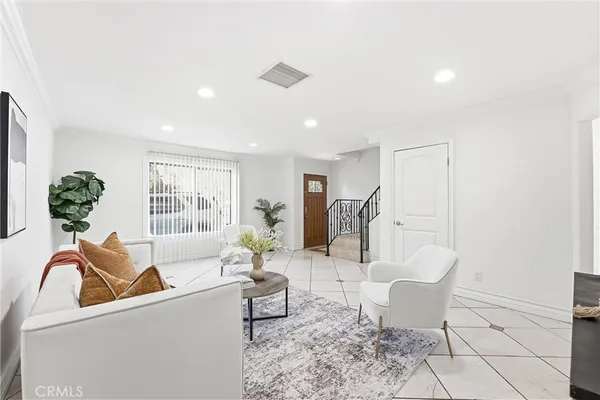 a living room with furniture and a potted plant