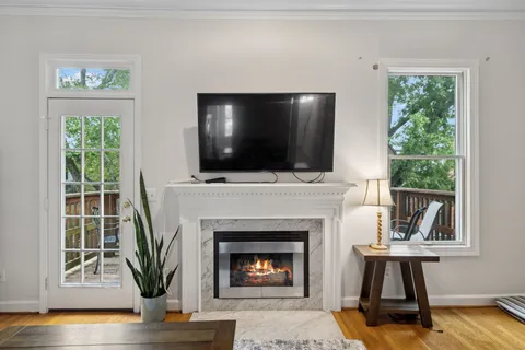 a living room with furniture and a fireplace