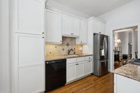 a kitchen with a sink and a refrigerator