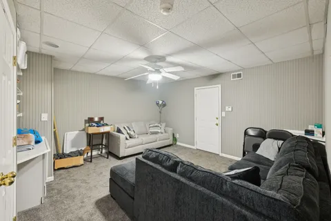 a living room with furniture and a chandelier