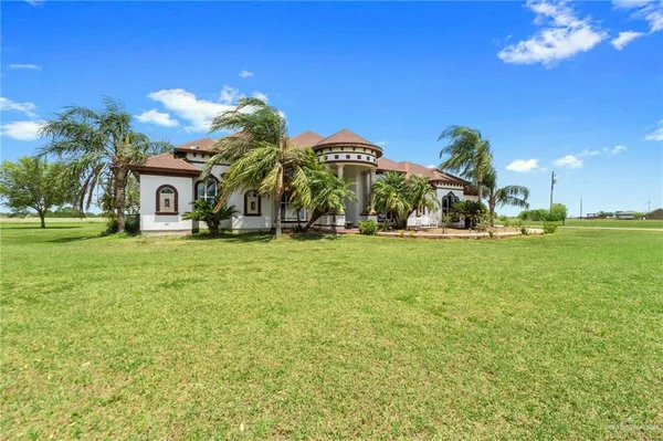 a view of a house with a yard