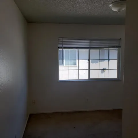 a view of a closet area with wooden floor